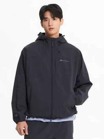 NBNAE31803 UNI ESS 2 LAYER Warm up Jacket CHARCOAL - NEW BALANCE - BALAAN 1