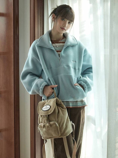 Minnie wearing ANC HALF ZIP FLEECE SWEATSHIRT BLUE - ANOETIC - BALAAN 2